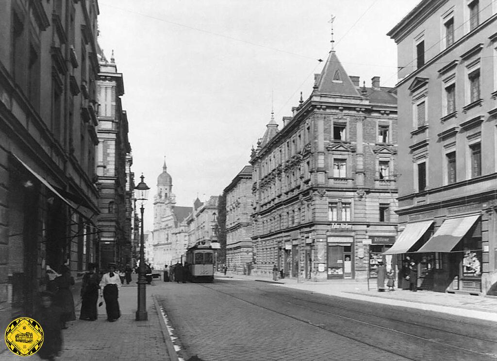 1910 steht ein Triebwagen in der Augustenstraße Ecke Zieblandstraße mit Blick auf die Josephskirche.