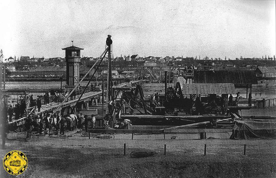 Das Bild aus dem Jahr 1870 zeigt die Baustelle der Braunauer Eisenbahnbrücke über Isar im Verlauf der Süd-Umfahrung Münchens.