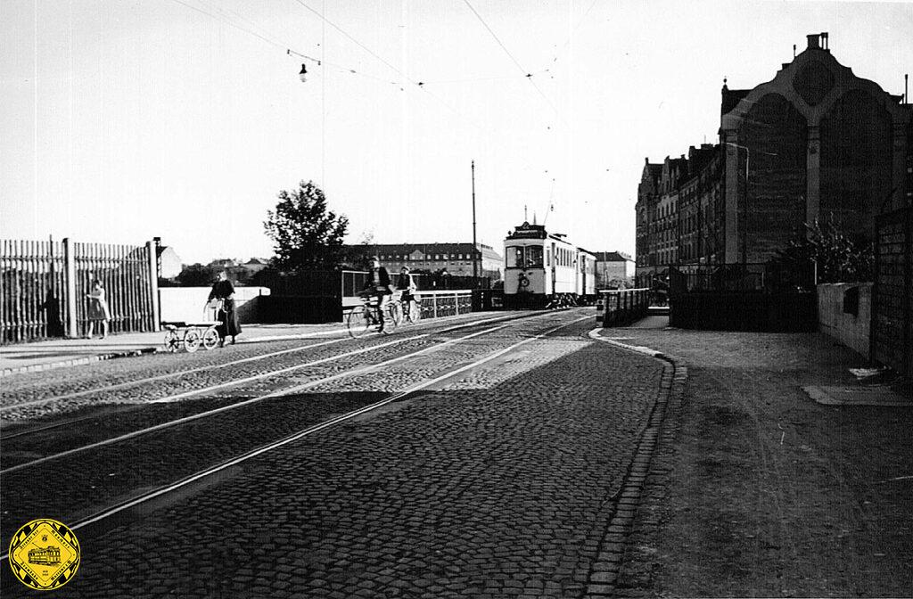 Bilderbuch-Aufnahme der Brücke der Trambahn in der Ganghoferstraße über die Eisenbahn. 1938 fährt ein A-Wagen auf der Linie 22 mit Beiwagen. Oft wurden Beiwagen beim A-Wagen nicht genutzt, allerdings war die Linienführung der Linie 22 recht eben, nur die Auf- und Abfahrt der Donnersbergerbrücke war eine kleine Steigung, die nach dem Umbau 1935 allerdings deutlich flacher war.