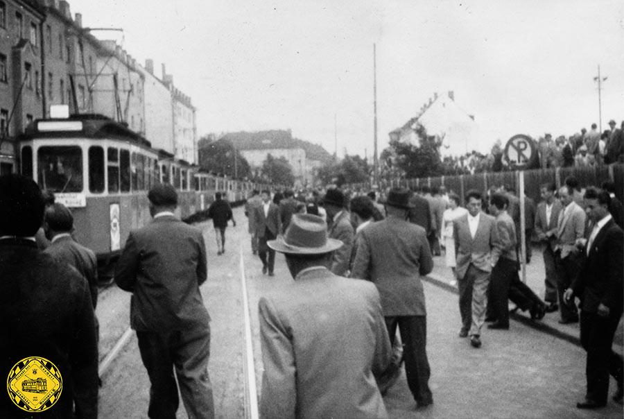 Fußballverkehr am 18. August 1957 nach einem Spiel im 60er-Stadion: die Trambahnwagen aus Richtung Wettersteinplatz fahren langsam an den Fussballfans vorbei, die auf die Trambahn aufsteigen können. Damit konnte man bis zu 1000 Personen in der Minute abtransportieren.